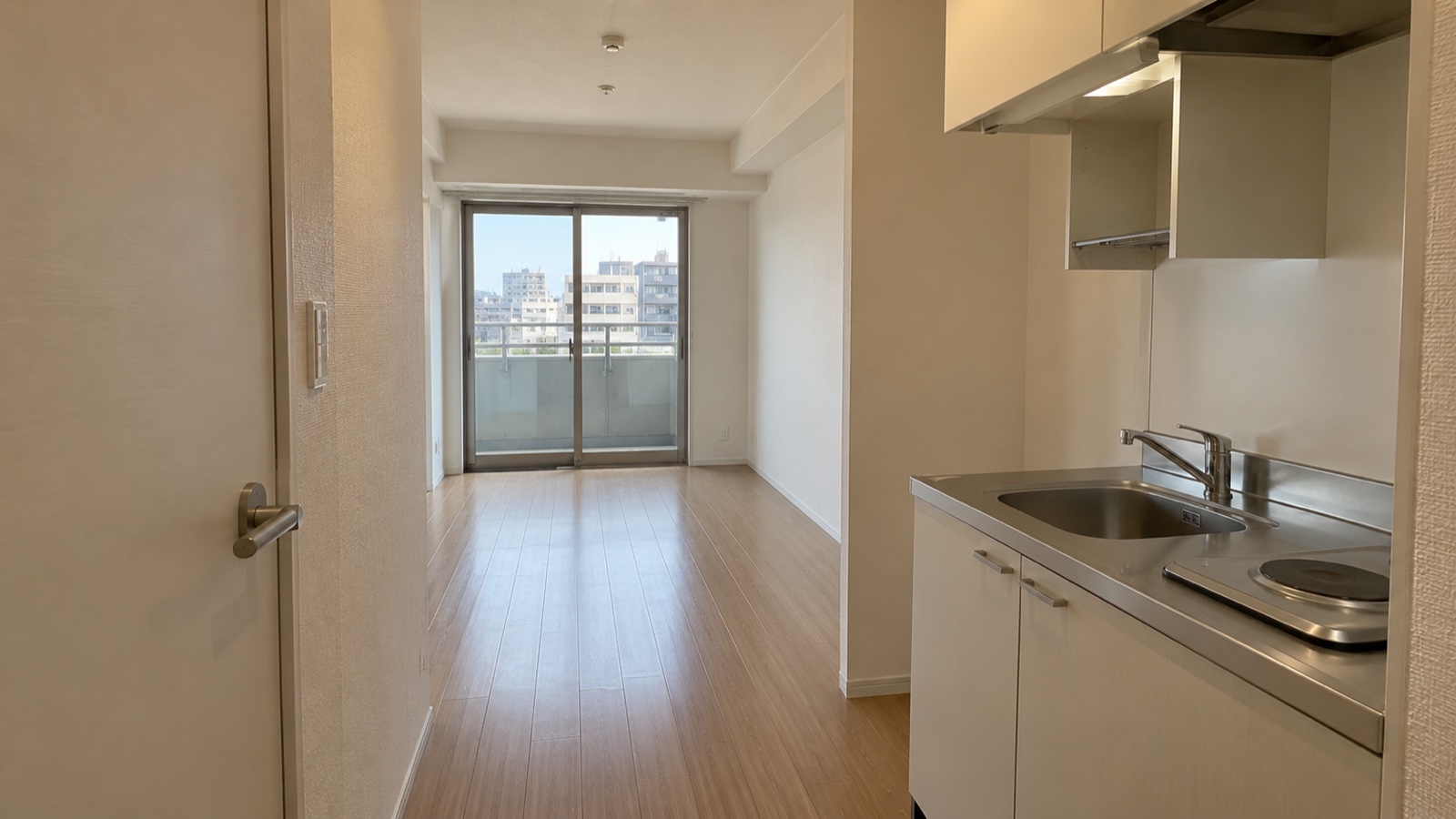 小さなキッチンと一部屋がつながるワンルームマンションの室内イメージ
